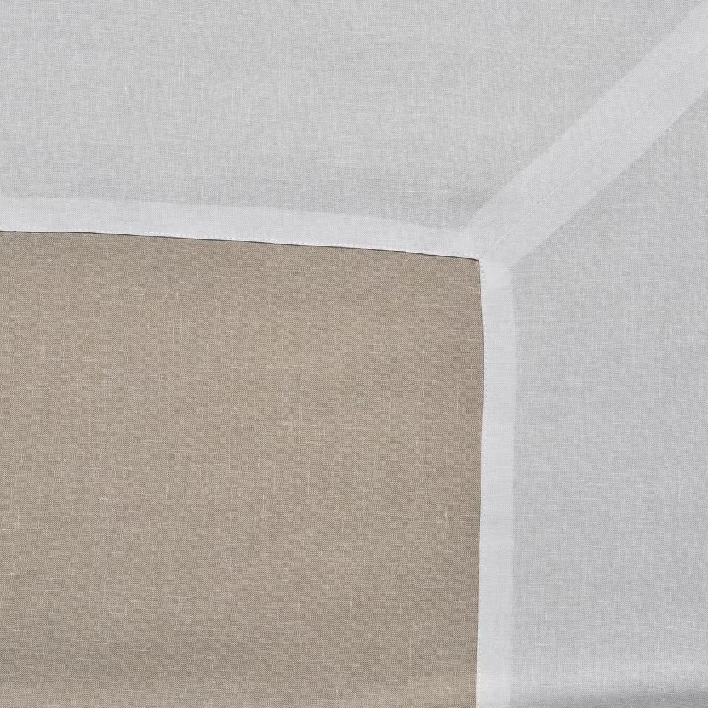 22 Maggio Istanbul Terreno Linen Tablecloth-Close-up of a textured beige wall corner with a white ceiling.