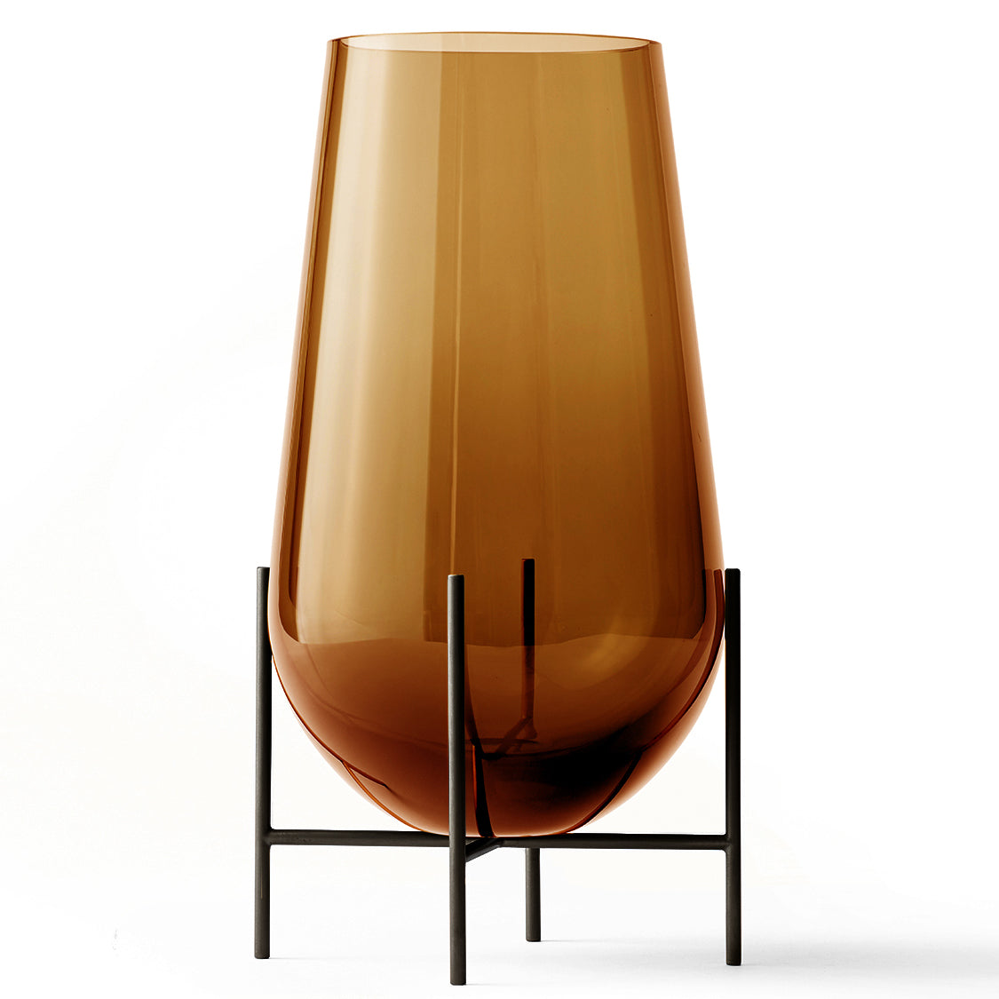 A brown, drop-shaped glass vase with a slender brass base resembling stilts, designed by Theresa Rand.