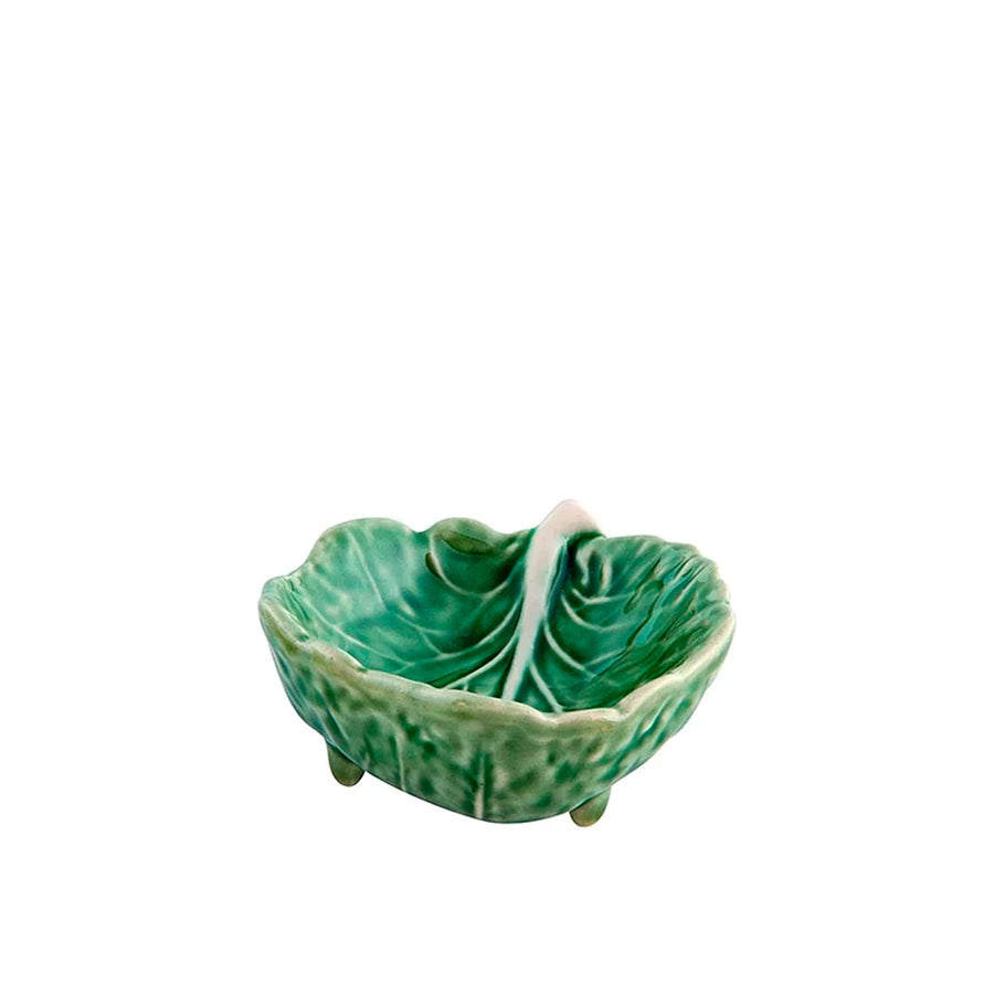 Green ceramic leaf-shaped dish on a white background