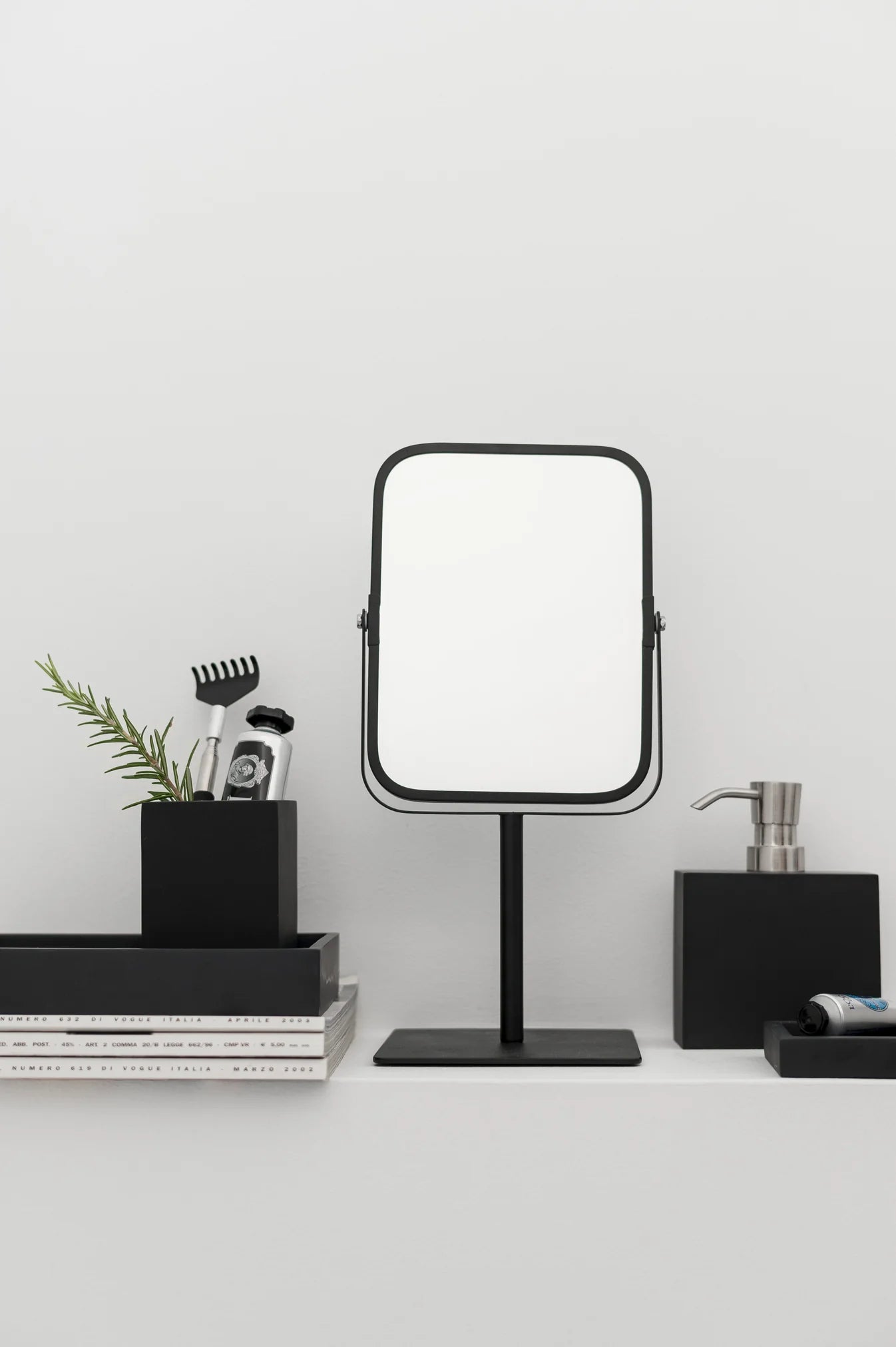 Aquanova Moon Mirror-Black stand-up mirror on a white surface with minimal decor-moon-mirror-on-dresser-with-mirror-dubai-beauty-lounge-crescent-dressing-table-mirror-uae-vanitymoon-wall-mirror-arabic-home-decor-dubai