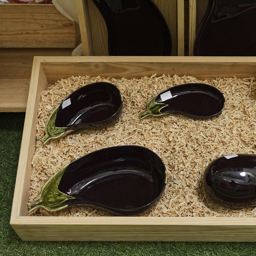 Bordallo Pinheiro Aubergine Salad Bowl-Black ceramic eggplant-shaped dishes on a wooden tray with a natural background