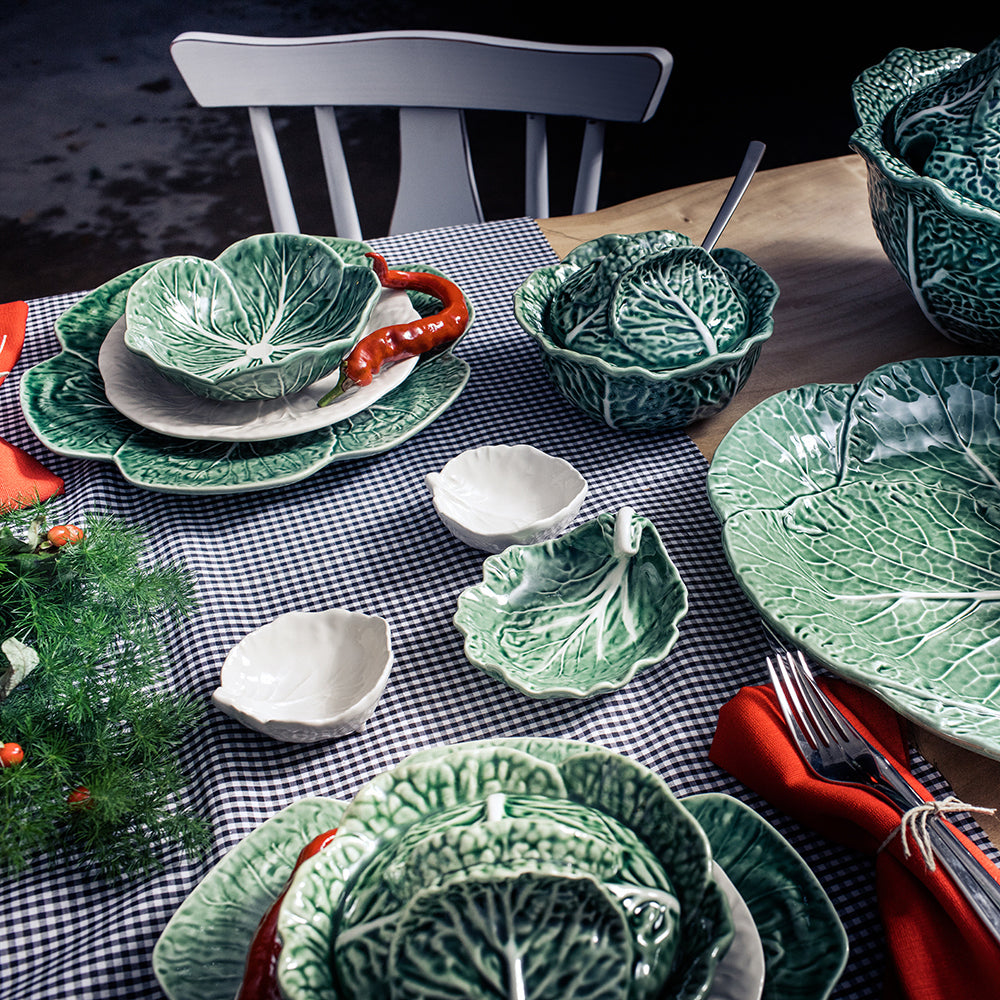Bordallo Pinheiro Cabbage Chip & Dip Bowl-Green ceramic cabbage-themed tableware on a checkered tablecloth with a dark background.