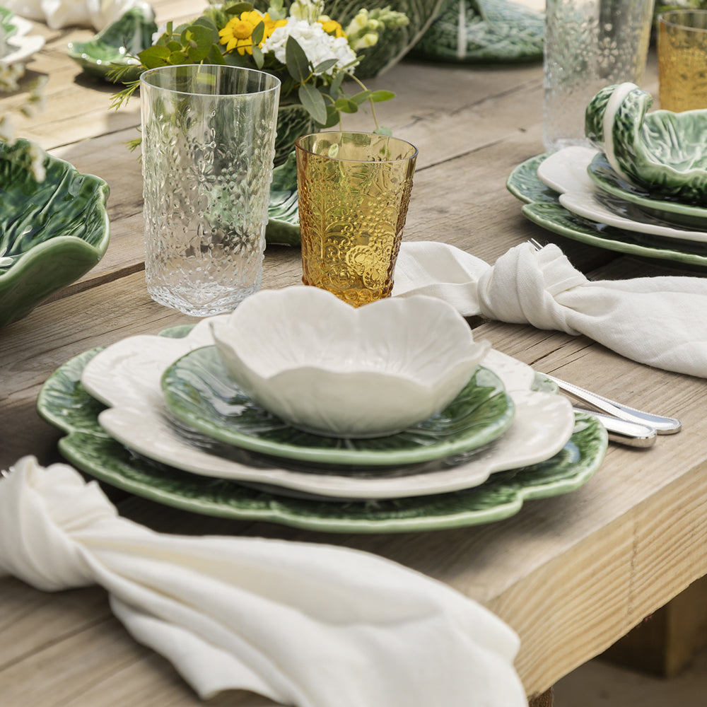 Bordallo Pinheiro Cabbage Dinner Plate-Dining table setting with green and white plates, glasses, and napkins.
