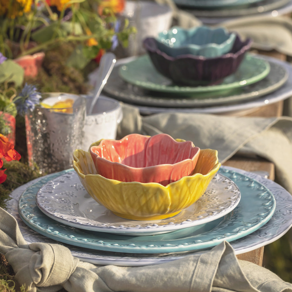 Bordallo Pinheiro Flora Dessert Plate-Colorful ceramic bowls and plates on a table with a blurred natural background
