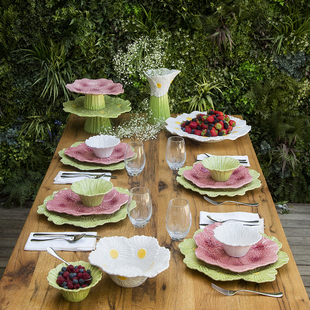 Bordallo Pinheiro Maria Flor Green Cake Stand-Dining table set with floral-patterned dishes and glasses outdoors.
