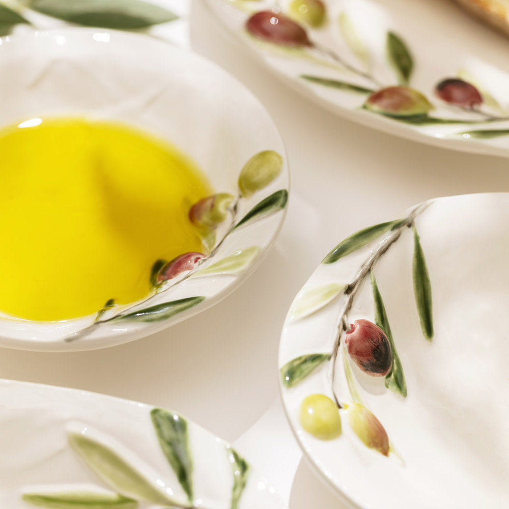 Bordallo Pinheiro Olival Small Bowl-White bowls with olive design containing a yellow liquid on a white background