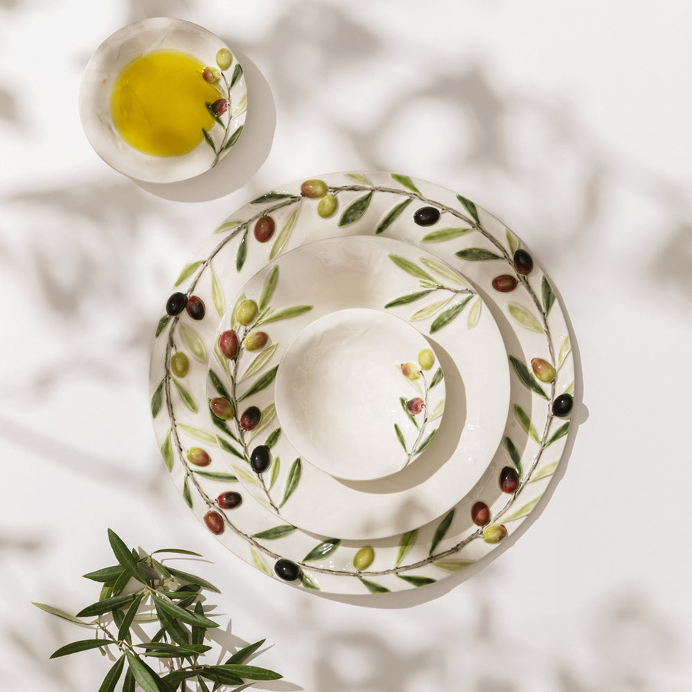 Bordallo Pinheiro Olival Small Bowl-Set of white ceramic plates with olive design on a light background