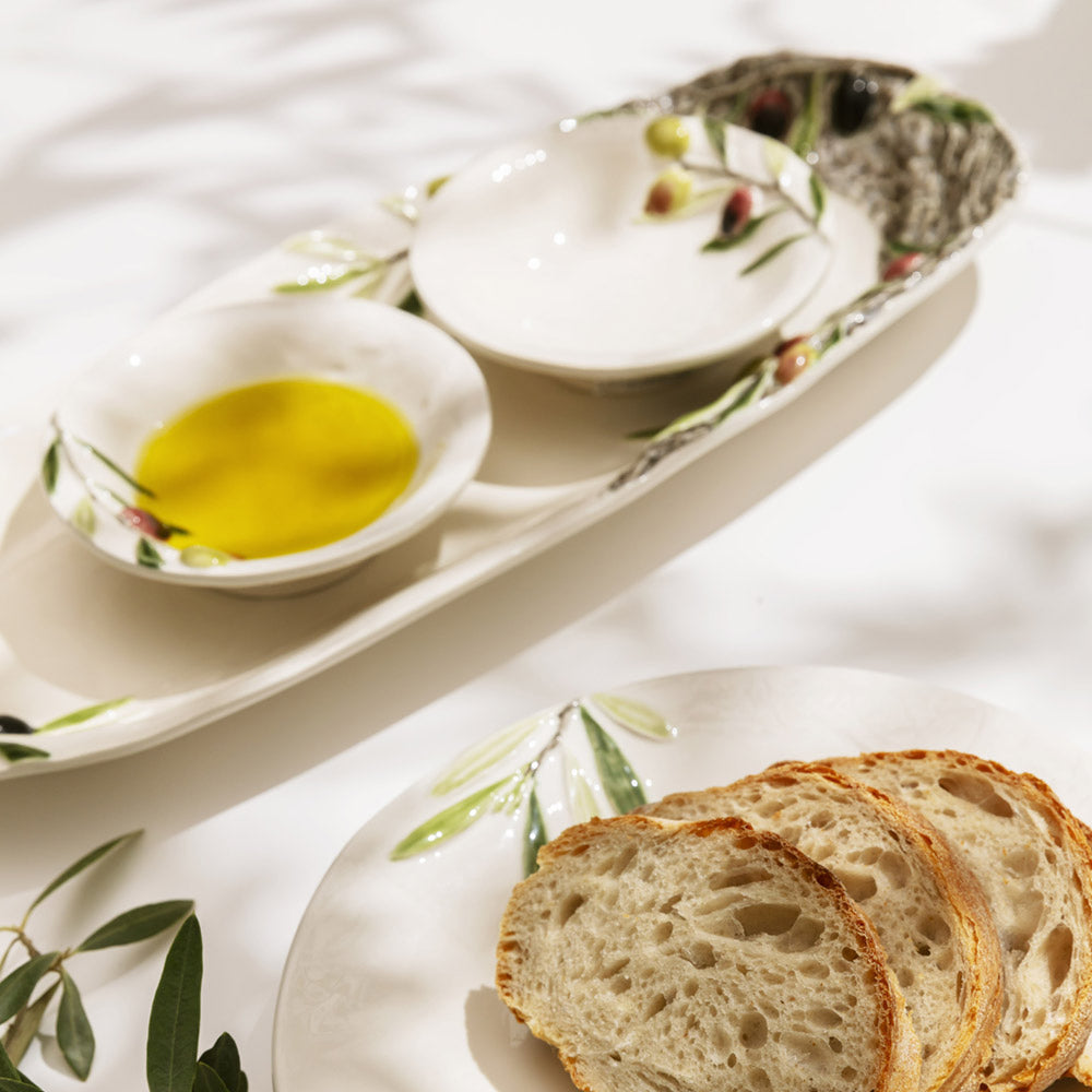 Bordallo Pinheiro Olival Small Bowl-Bread slices on a decorative plate with olive oil and olives.