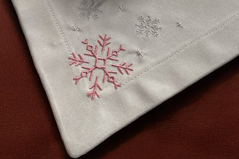 Cristallo Placemat Set of 4-Embroidered snowflake design on a fabric surface