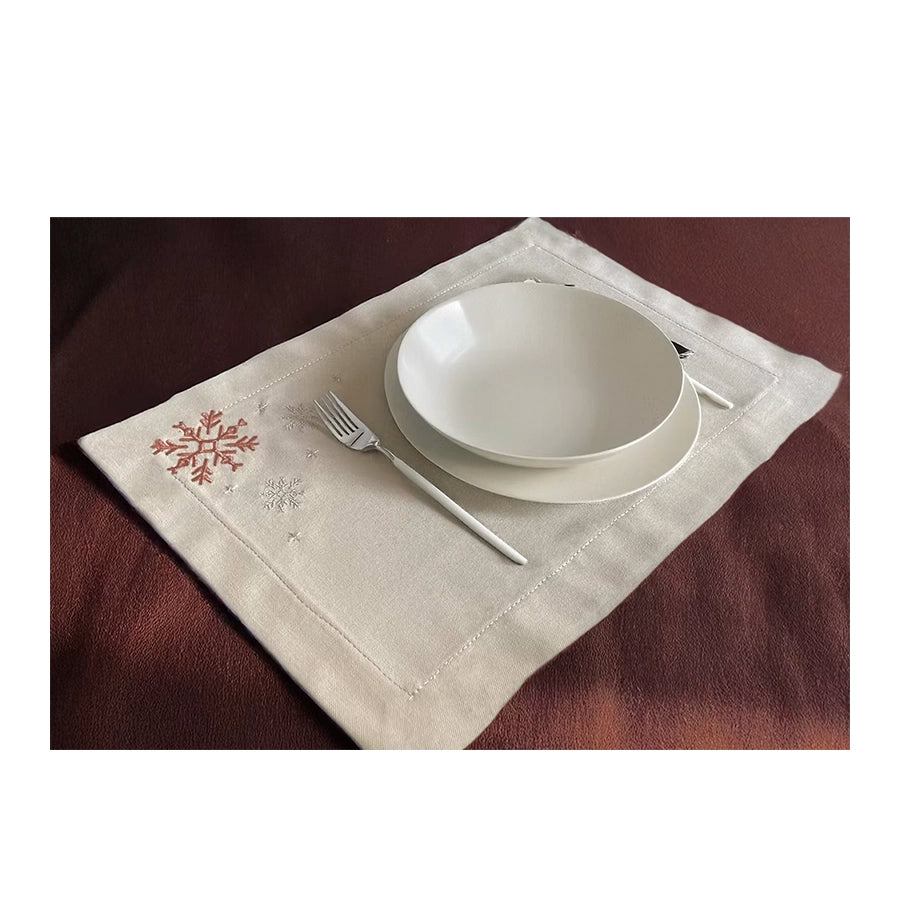 Cristallo Placemat Set of 4-White ceramic bowls on a decorative placemat with cutlery on a brown surface