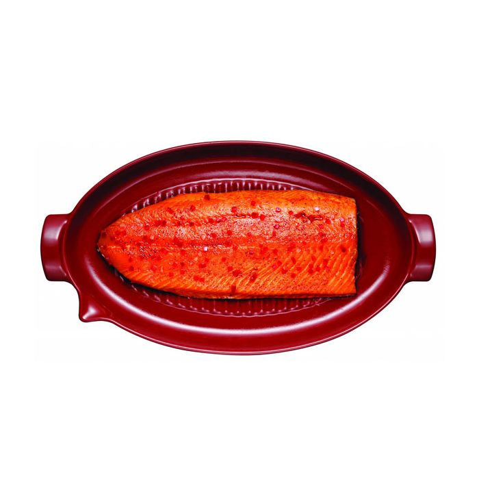 Emile Henry Covered Fish Steamer-Raw salmon fillet in a red ceramic dish on a white background