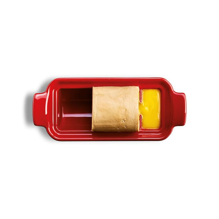 Emile Henry Foie Gras Medallion Terrine-Red ceramic butter dish with a block of butter and a knife on a white background