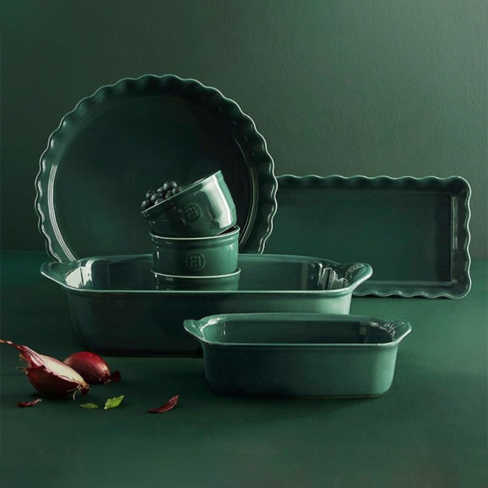 Emile Henry Rectangular Oven Dish-Set of green ceramic dishes on a dark green background
