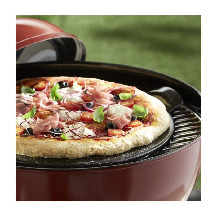 Emile Henry Smooth Pizza Stone, 36cm-Pizza on a portable pizza oven with a blurred green background