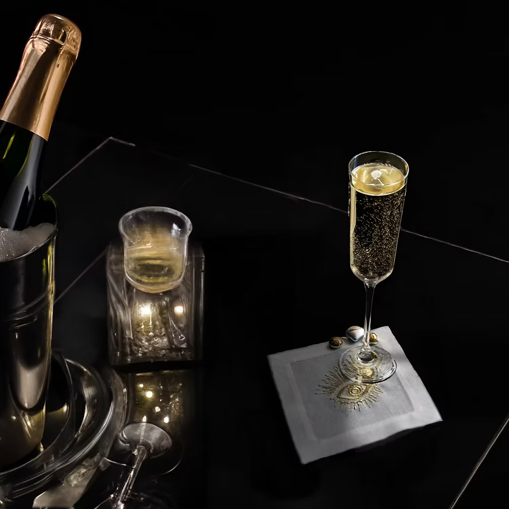 Fatima Linen Coasters Set of 4-Bottle of champagne with two glasses on a dark surface