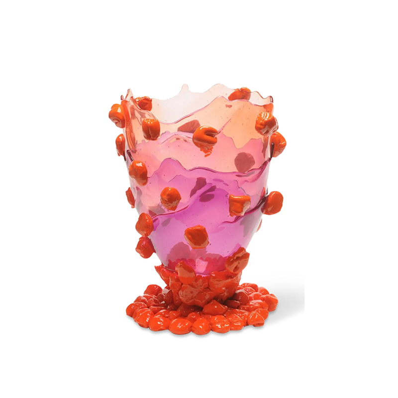 A multicolored resin vase with a geometric pattern and fish designs in red and pink hues.