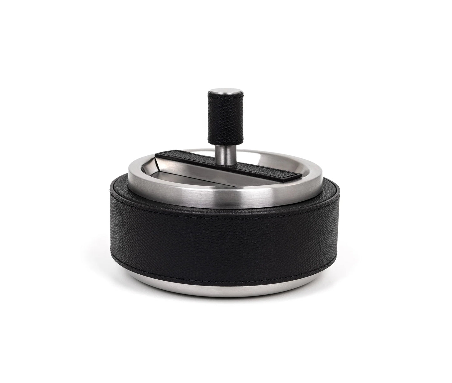 A round, stainless steel ashtray with a black leather cover and a central spinning element.