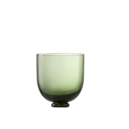 Green glass cup on a white background