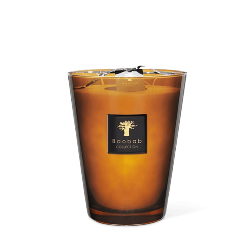 A clear amber-hued glass scented candle with a label that reads 'Baobab Collection' and has an image of a tree in the background.