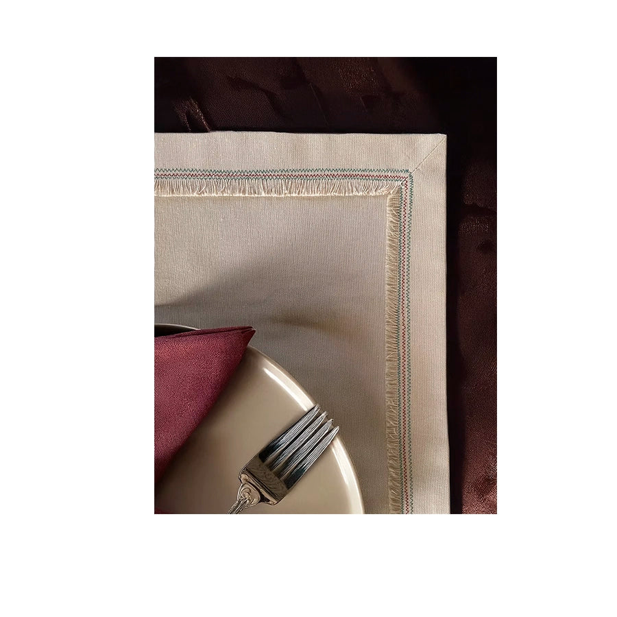 Nappina Placemat Set of 4-Beige napkin with a decorative edge on a white background