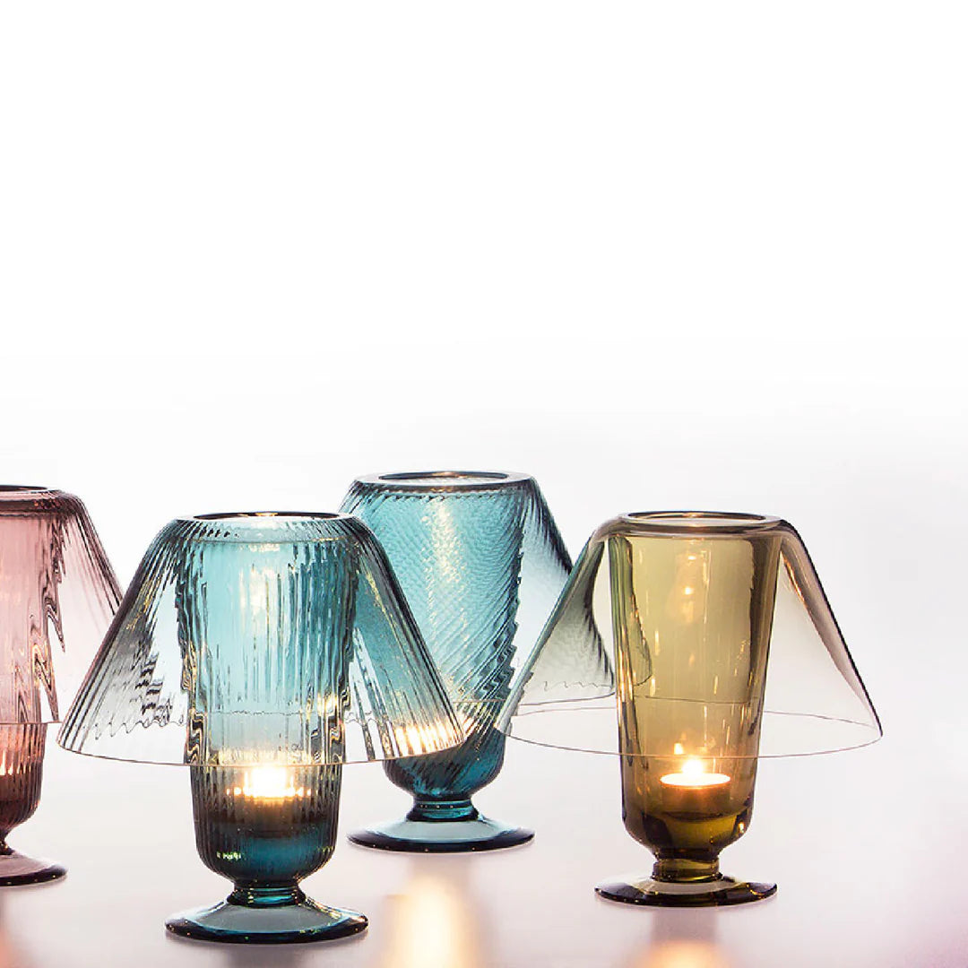 Set of colorful glass candle holders on a white background