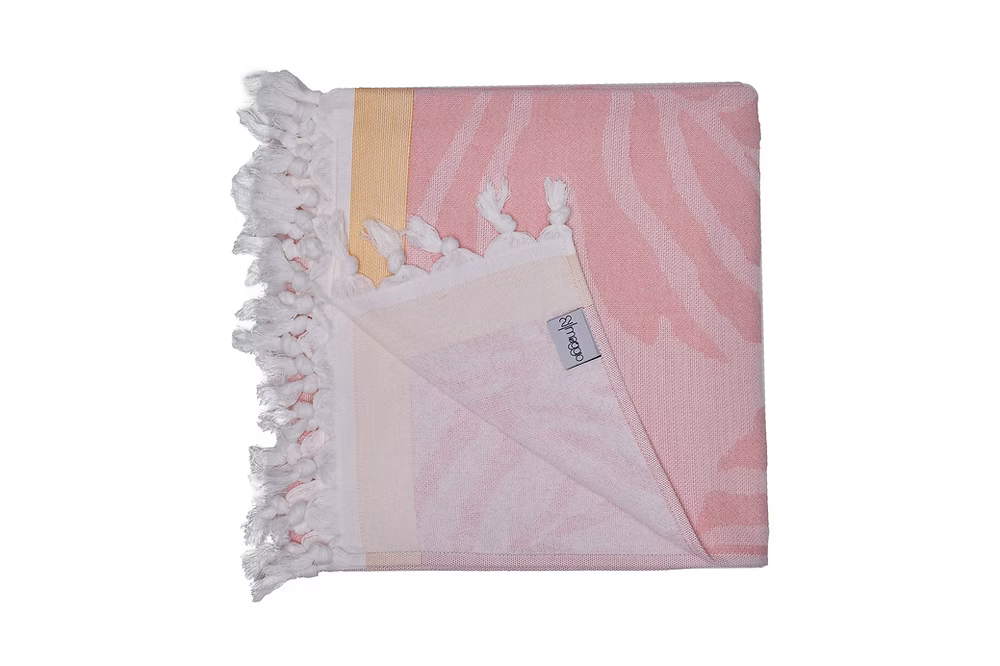 Premium Vivace Cotton Beach Towel-Pink and white patterned blanket with tassels on a white background
