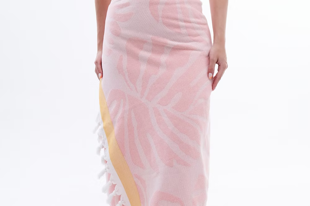 Premium Vivace Cotton Beach Towel-Pink and yellow patterned towel with tassels on a white background