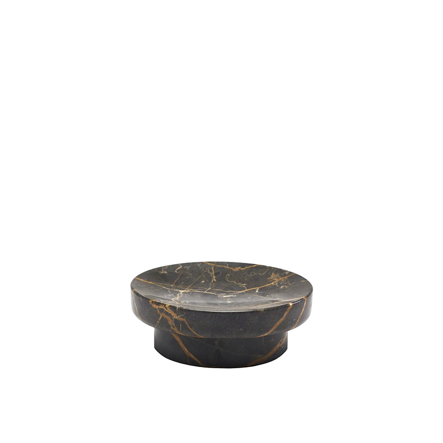Round black marble coaster with gold veins on a white background