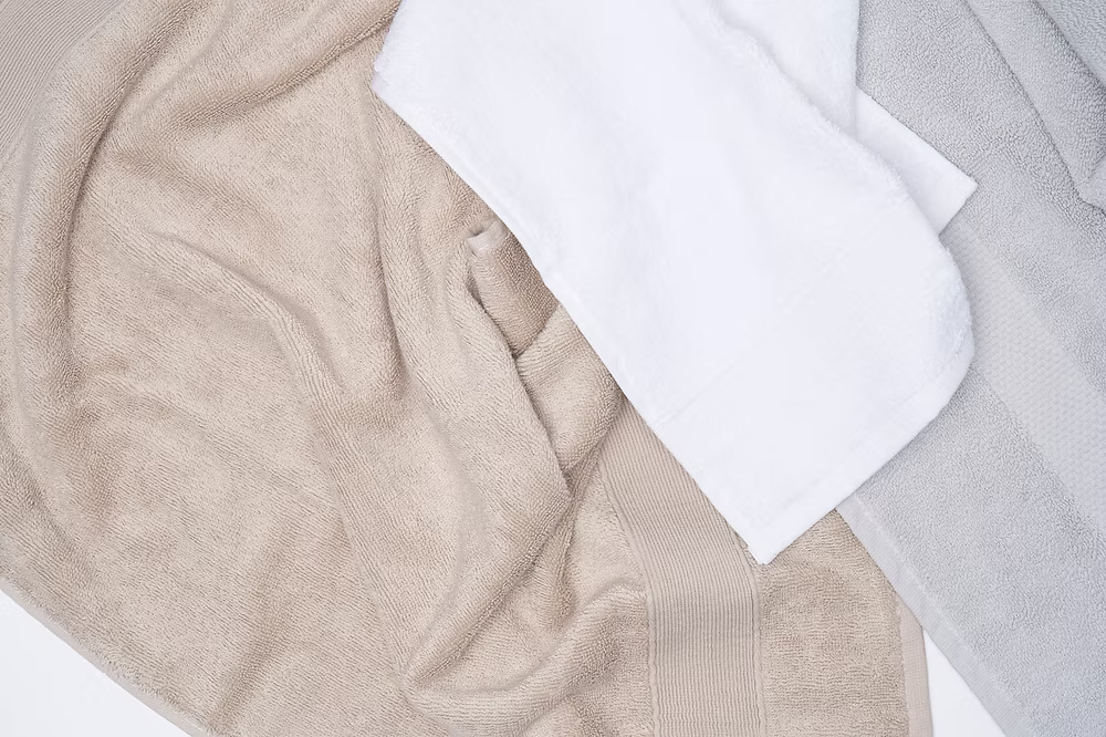 Sardegna Towel Set-Close-up of beige, white, and gray textured fabrics on a white background