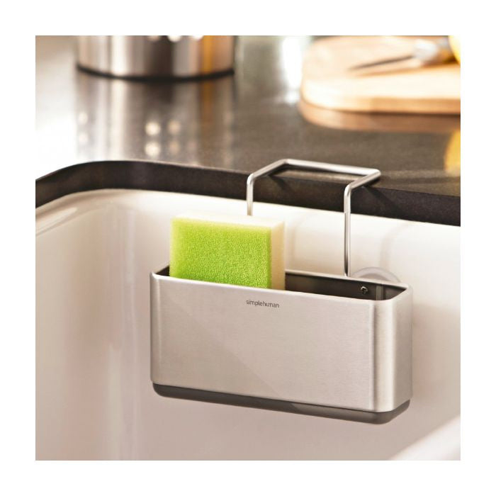 Simplehuman Slim Sink Caddy-Stainless steel sink caddy with a green sponge on a kitchen counter.