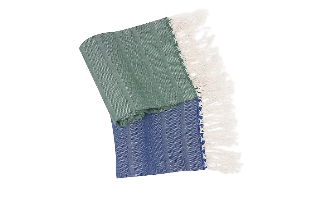 Sole Beach Towel (Navy)-Folded fabric with green and blue pattern and white fringe on a white background