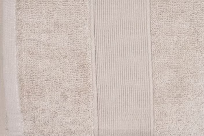 Verona Towel Set-Close-up of a textured beige rug with a subtle pattern