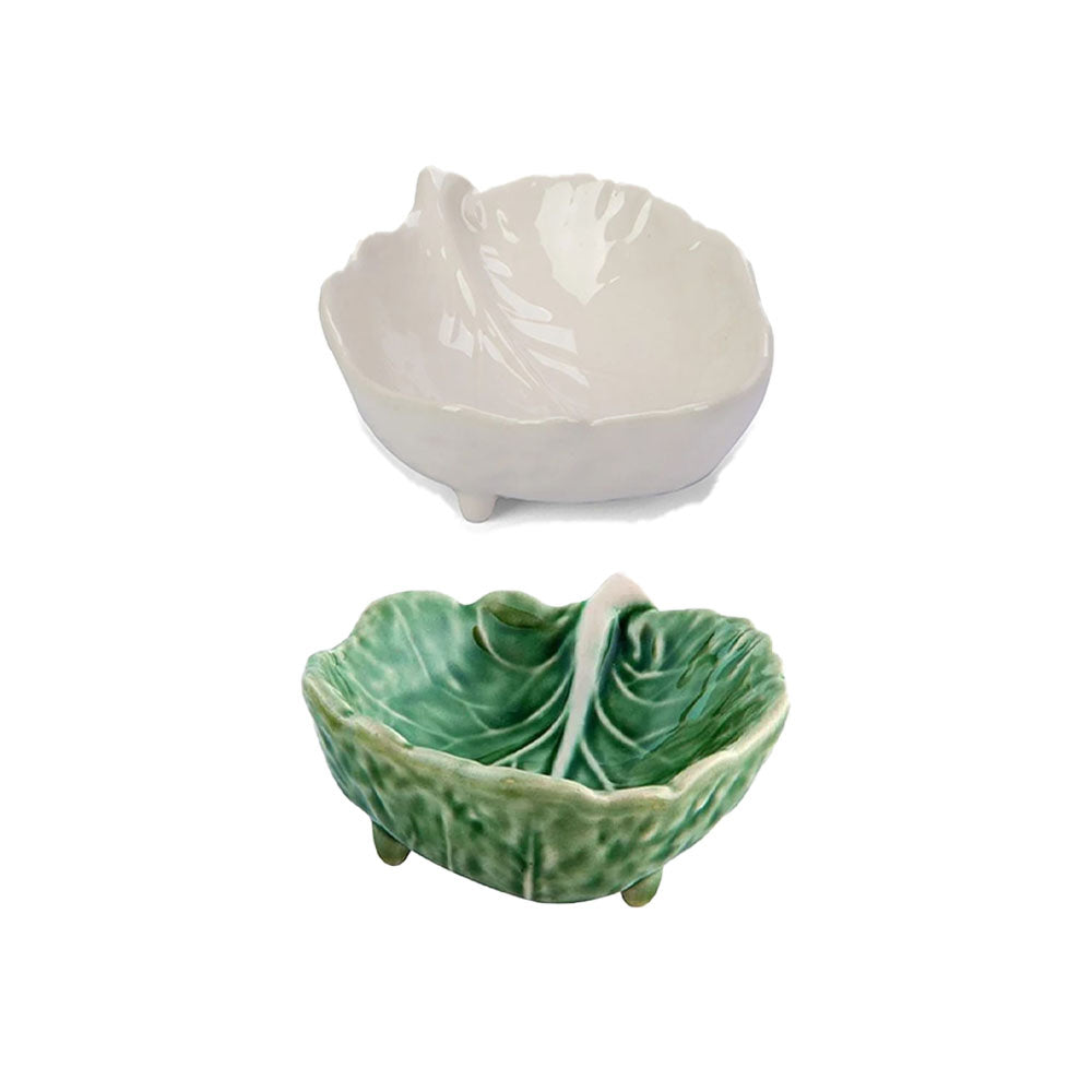 Two ceramic leaf-shaped bowls, one white and one green, on a white background.