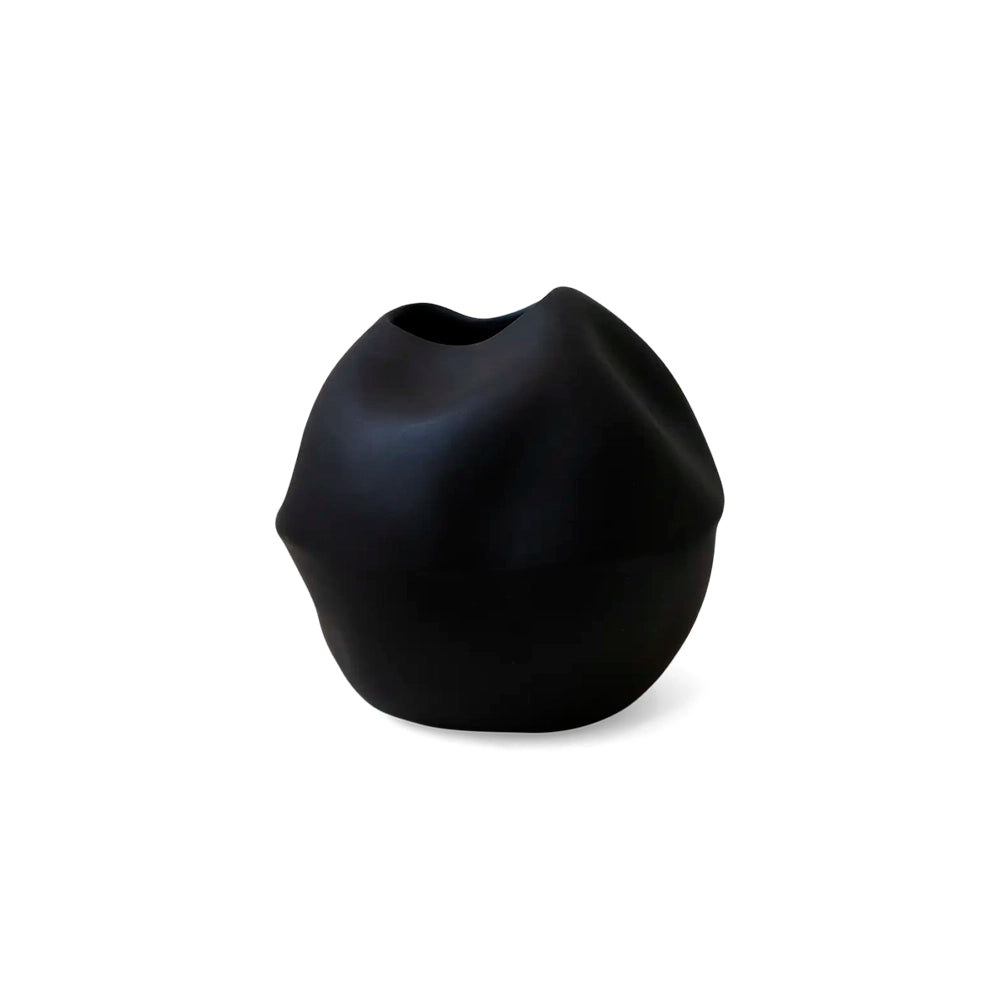 A medium-sized black ceramic vase with an abstract shape.