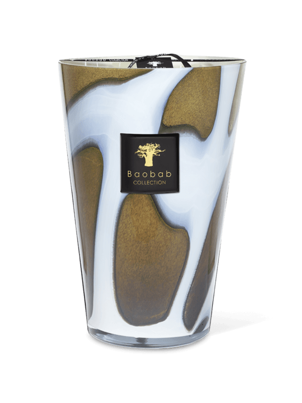 A clear glass candle holder with a white and gold agate pattern, containing a scented candle, with a black label that has the 'Baobab Collection' logo.