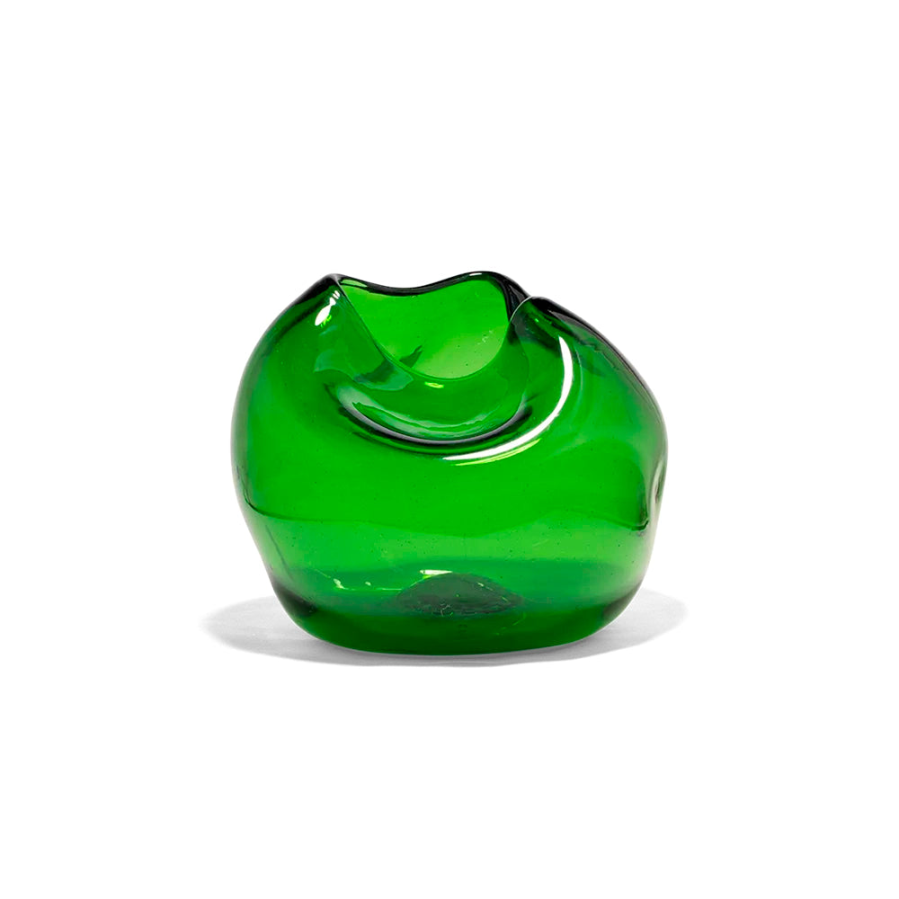 A green, curved glass vase made from recycled materials with a smooth finish.