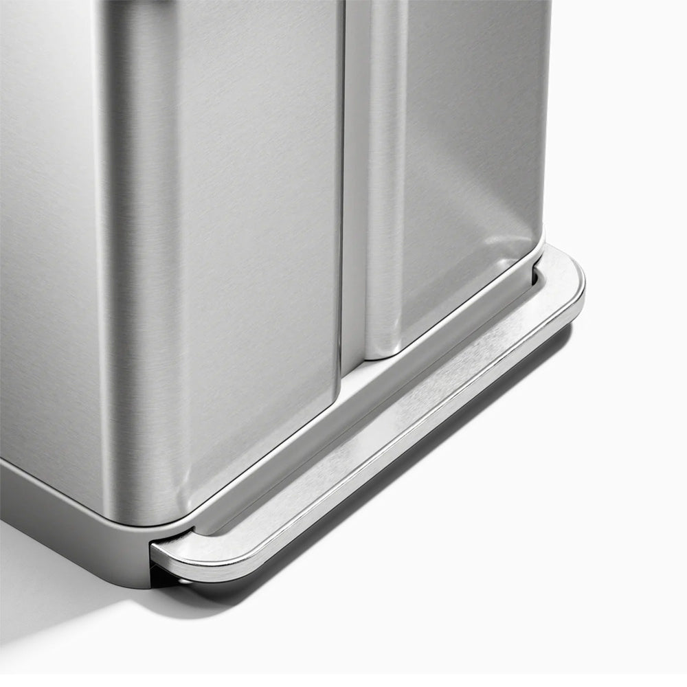 Close-up of a metallic trash can with a white background