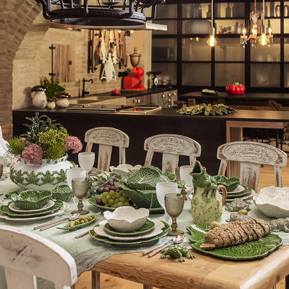 Dining table set with greenware in a rustic kitchen