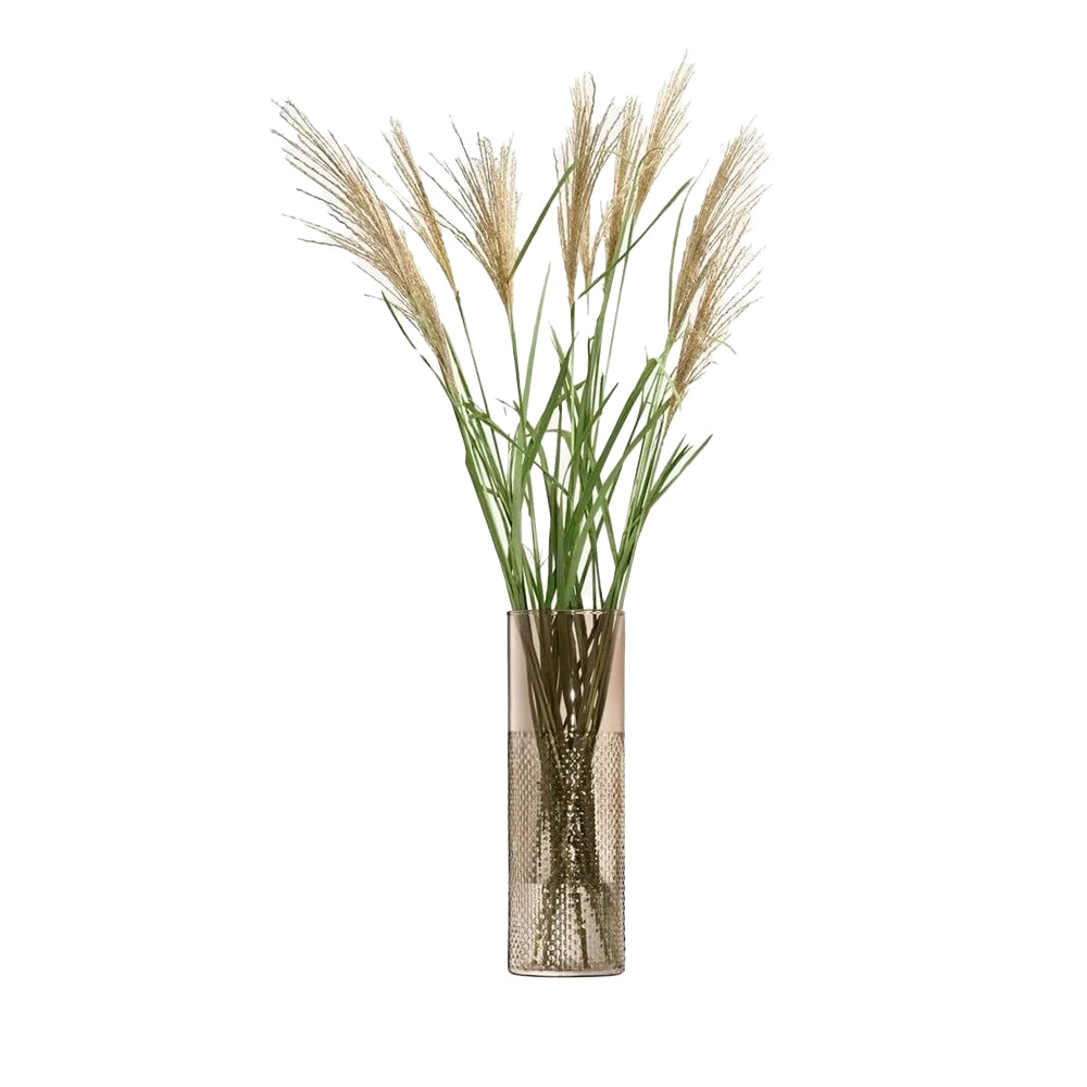 A cylindrical glass vase with a wicker-inspired texture, clear and cased-colored, containing a arrangement of dried grasses.