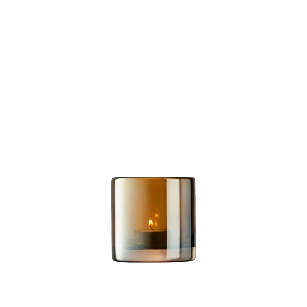 A handcrafted glass tealight holder with a translucent orange and gray color, featuring a mouth-blown design with a thick base.