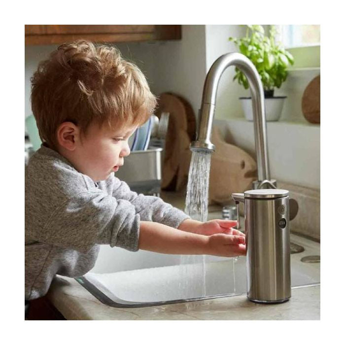 simplehuman Rechargeable Sensor Soap Pump-Child washing hands under a running faucet with a soap dispenser in a kitchen.