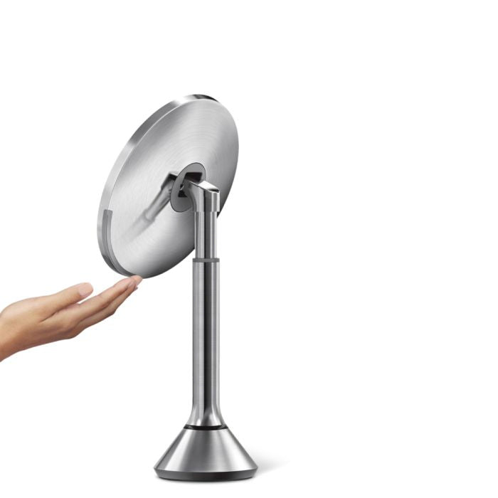 simplehuman Round Sensor Mirror Handheld shower head with a stand on a white backgrounddresser-with-mirror-uae-beauty-lounge-dressing-table-mirror-dubai-luxury-vanity-wall-mirror-for-dubai-bedrooms