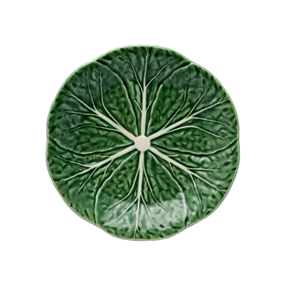 Round green pillow with pleated texture on a white background