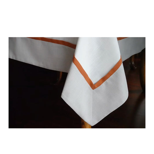 22 Maggio Istanbul Calvino Designer Table Cloth-White tablecloth with brown trim on a table