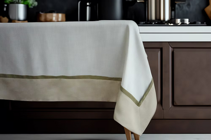 22 Maggio Istanbul Cavalcanti Designer Table Cloth-Beige tablecloth with green trim on a kitchen table