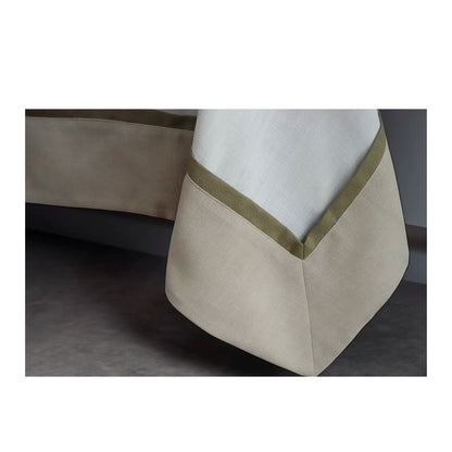 22 Maggio Istanbul Cavalcanti Designer Table Cloth-Close-up of a beige and white fabric with a green trim on a dark background