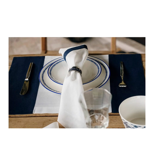 22 Maggio Istanbul Marinaio  Linen Napkin Set of 4-Dining table setting with blue and white plates, napkin, and cutlery on a wooden table.