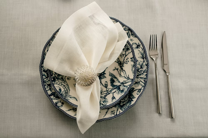 22 Maggio Istanbul Sereno Linen Napkin Set of 4-Decorative plates with a napkin and cutlery on a textured surface