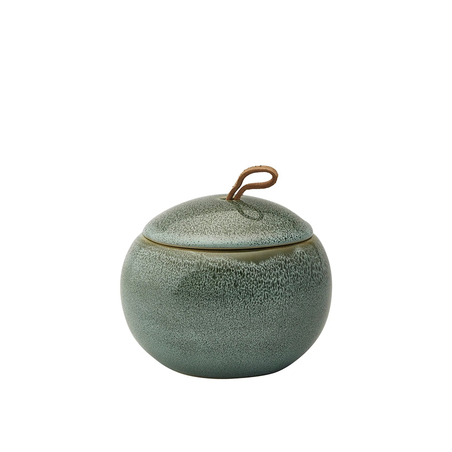 Green ceramic jar with textured surface and metallic handle on a white background