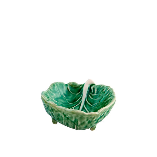 Green ceramic leaf-shaped dish on a white background